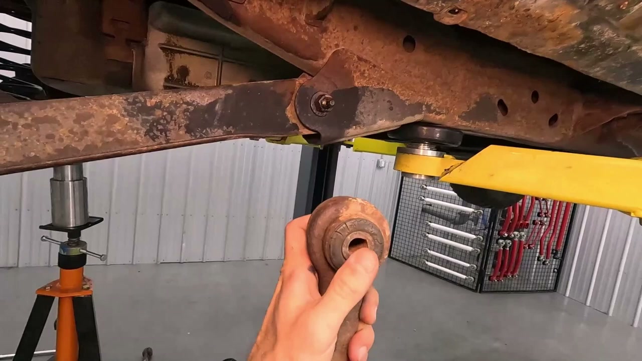 Old fused-rubber factory bushing removed from the Tahoe, showing the crush sleeve that caused preload on the bushing