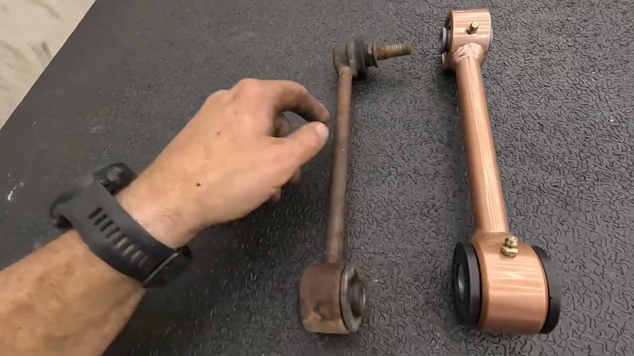 Side-by-side comparison of the thin factory Tahoe sway bar end link next to the Core 4x4 3/4-inch cold-rolled steel end link