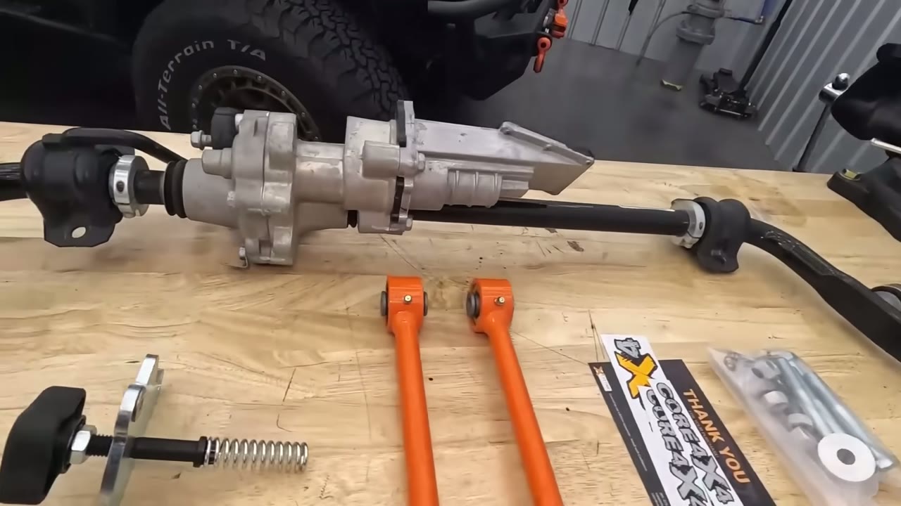 EVO manual disconnect conversion kit laid out on the bench with a Rubicon sway bar, the manual knob, and Core 4x4 Crawl Series end links