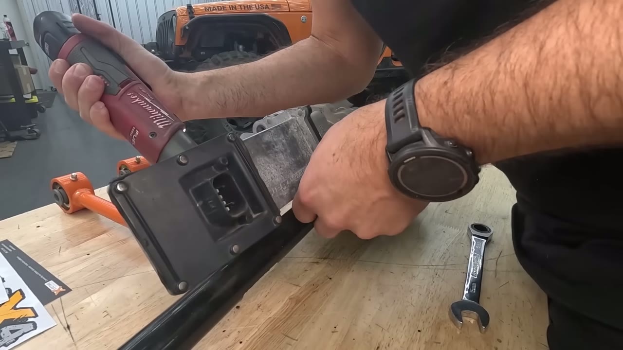 Disassembling the factory electronic actuator from the Rubicon sway bar with a ratchet on the workbench
