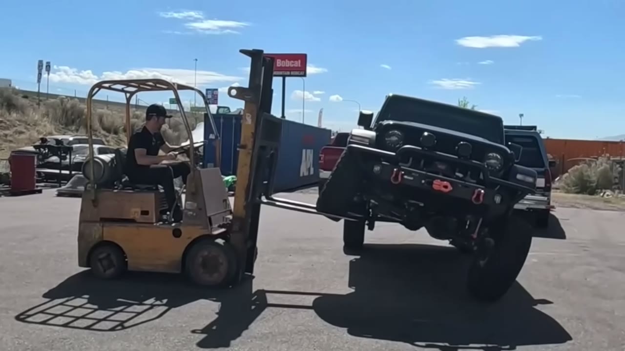 JL Wrangler front end lifted on a forklift ramp during the connected versus disconnected sway bar flex test